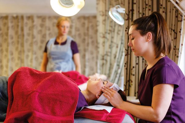 Cornwall College beauty student in salon doing head massage