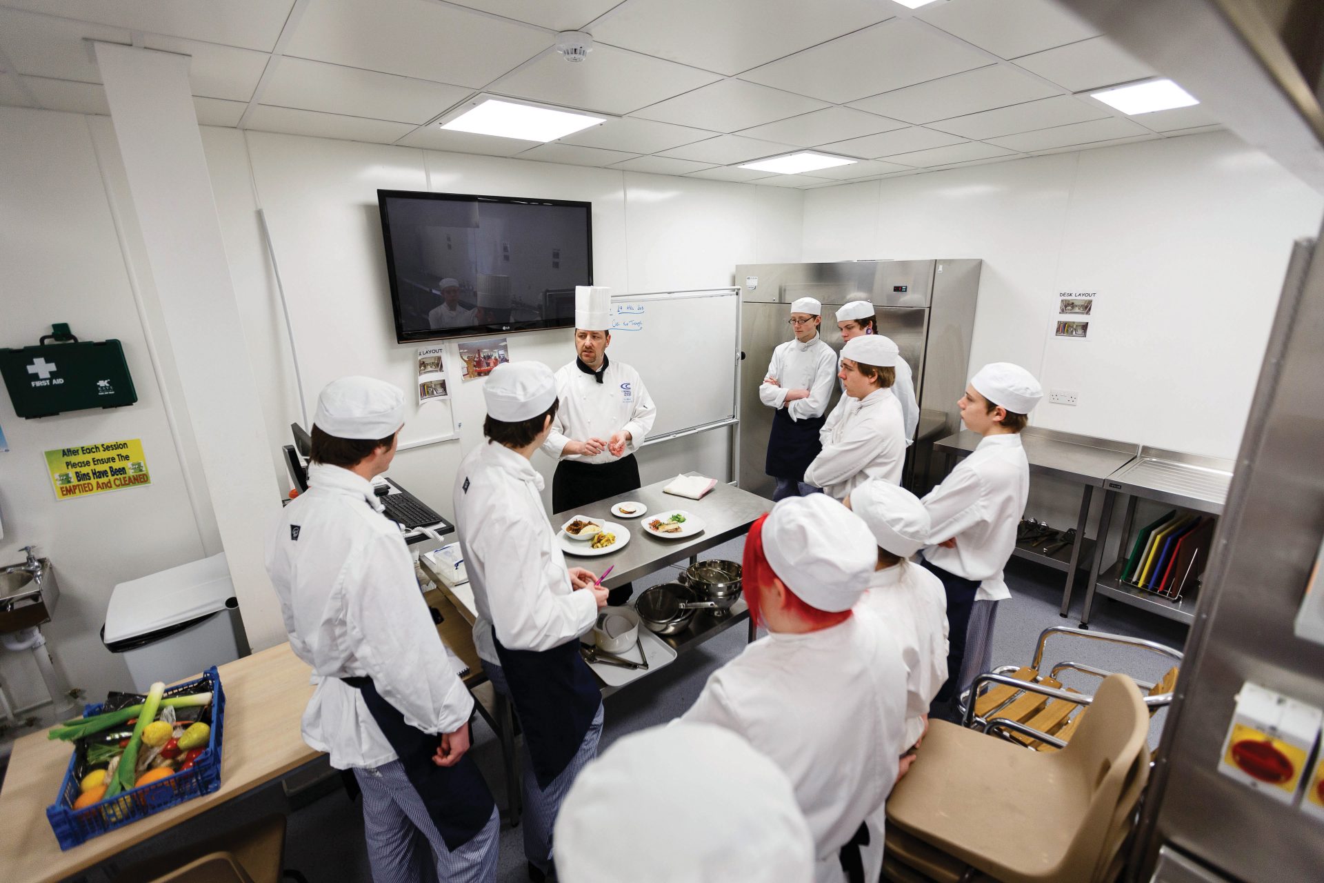 Group of chef students being taught by chef lecturer in training kitchens at Cornwall College