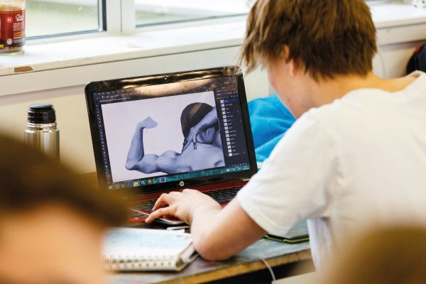 Young person looking at a laptop