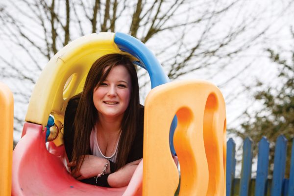 Early years student in childrens' play park outdoors