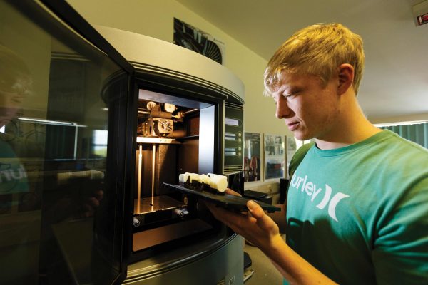 Engineering degree student operating a 3D printer at Cornwall College