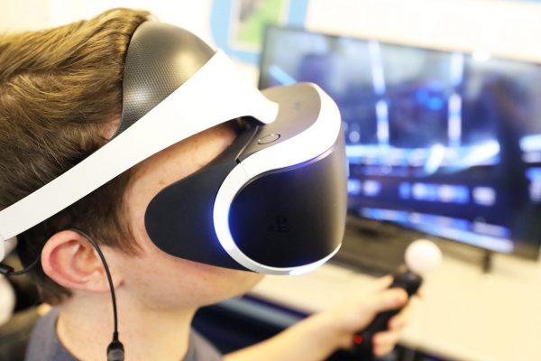 Games design student previews a game through VR headset at Cornwall College