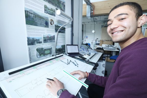 Student at drawing board studying garden design degree at The Eden Project