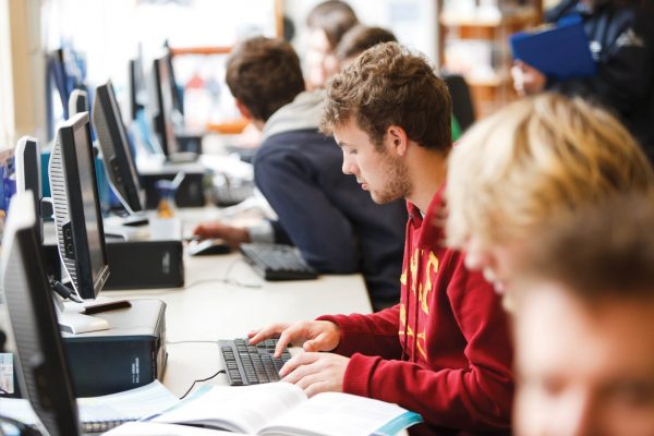 Students working at computers in a library