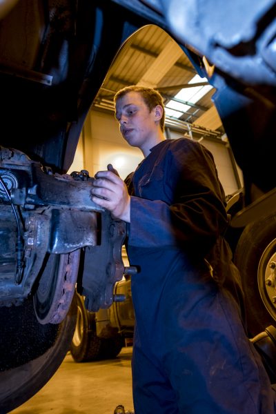 Student mechanic working on HGV