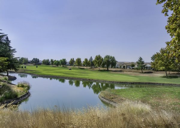 Golf club green, clubhouse & carts by lake