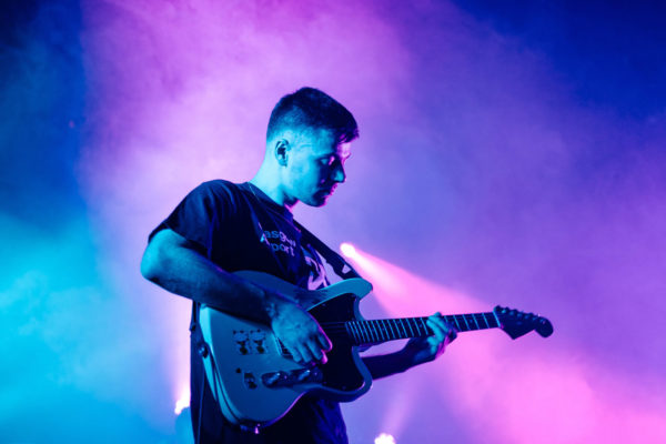 A guitarist playing live