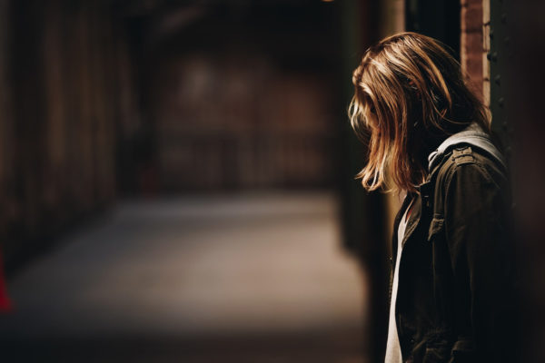 A child stands isolated in an urban setting