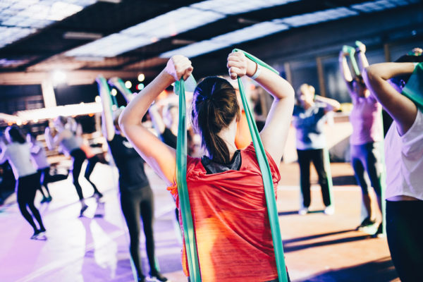 A gym instructor holding resistance straps