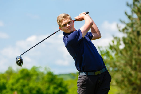 Golf student practising his swing