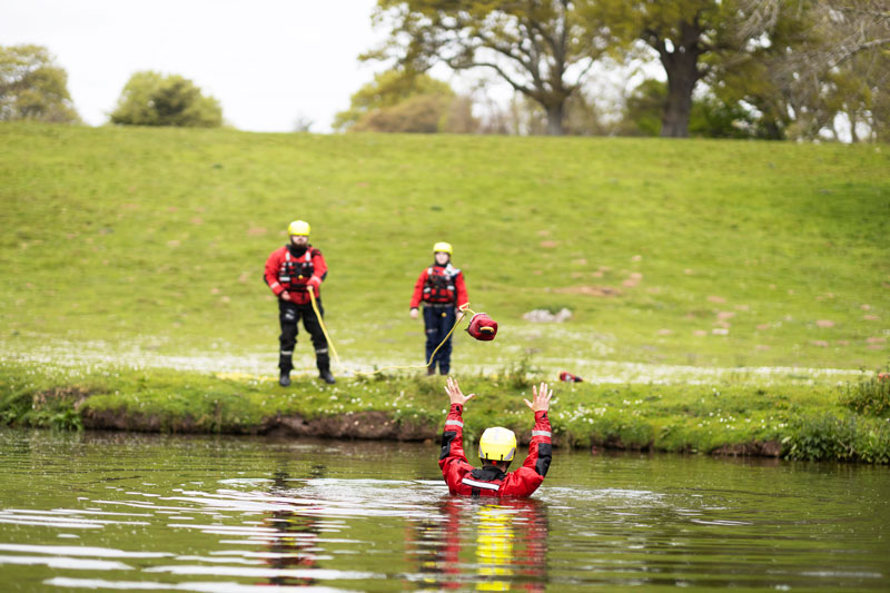Emergency services students on an exercise rescuing someone from a lake