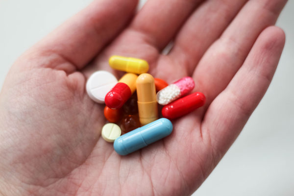 A variety of colourful tablets in someone's hand