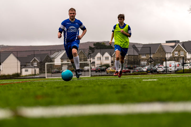 Sports and fitness students playing football