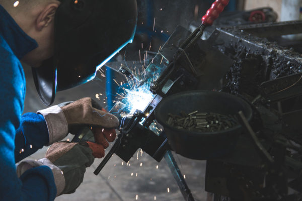 An engineering student welding