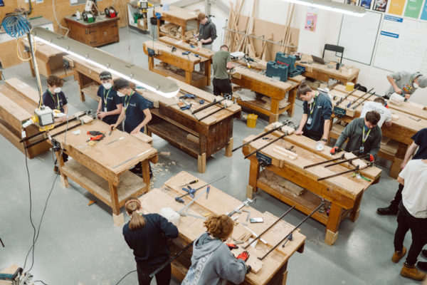 Students studying carpentry in a workshop