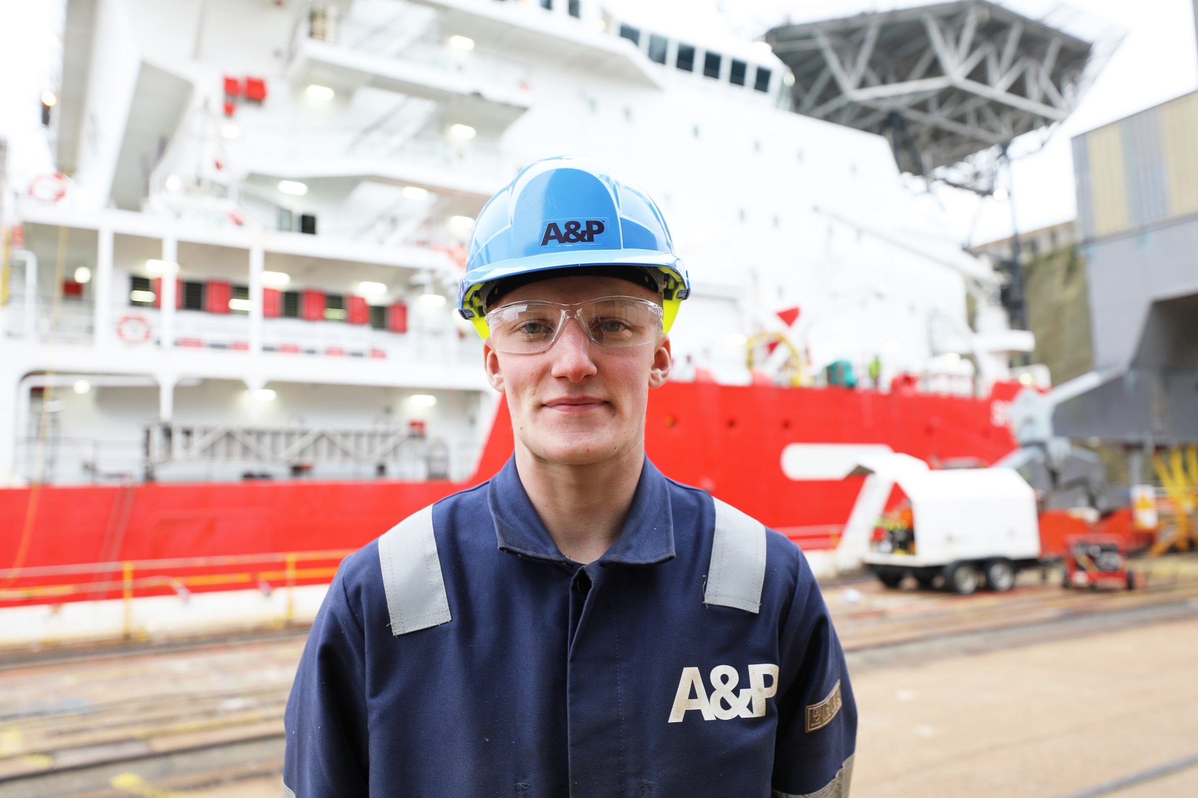 Apprentice in front of a ship at A&P Falmouth